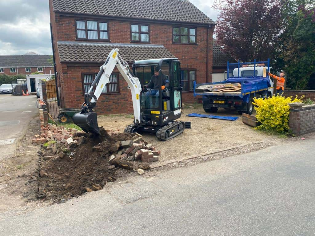 This is a photo of an operative of Wymondham Driveway Contractors. Digging out for a new tarmac driveway